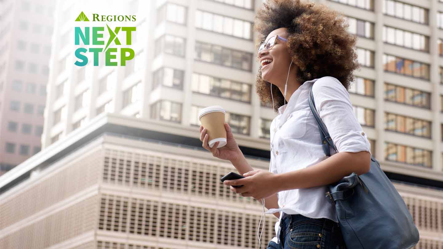 young african american woman listening to music in the city