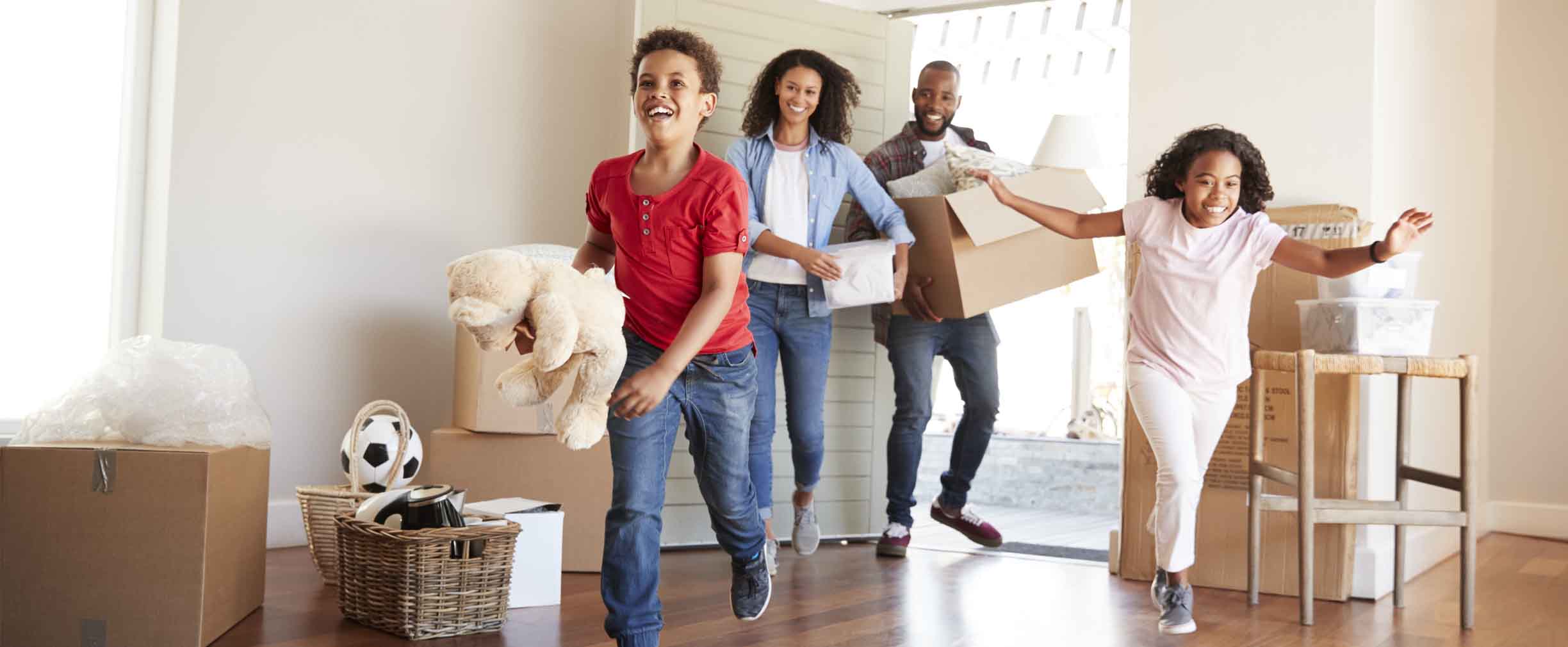 young family moving boxes into their new home