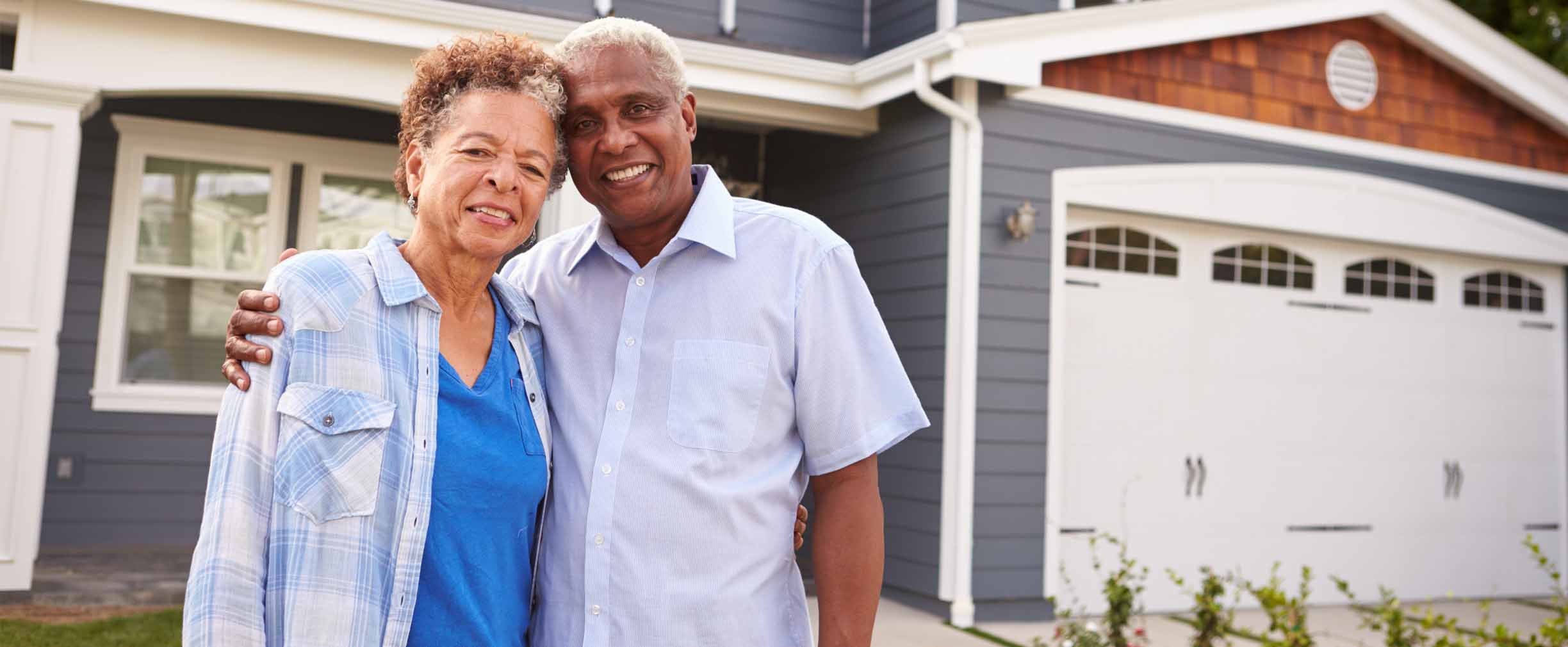 couple in front of new home