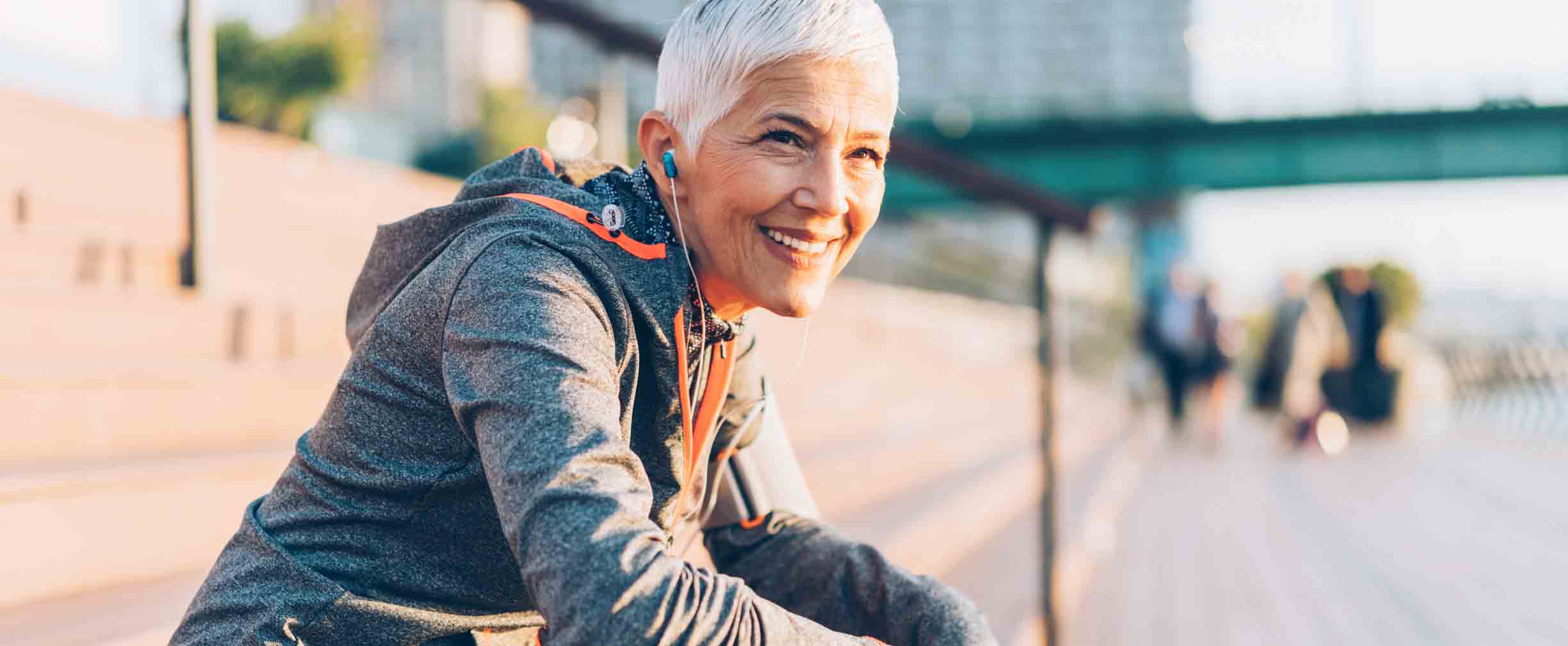 female senior sitting on a bench after a run