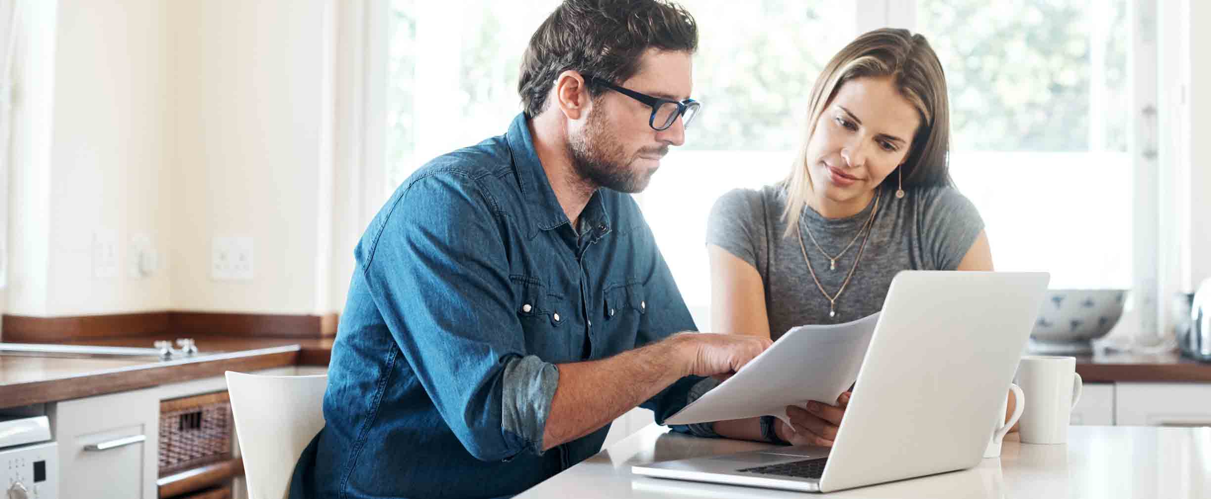 Young couple working on their finances together at home